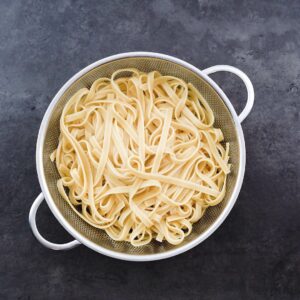 Cooked Drained Pasta in a strainer.