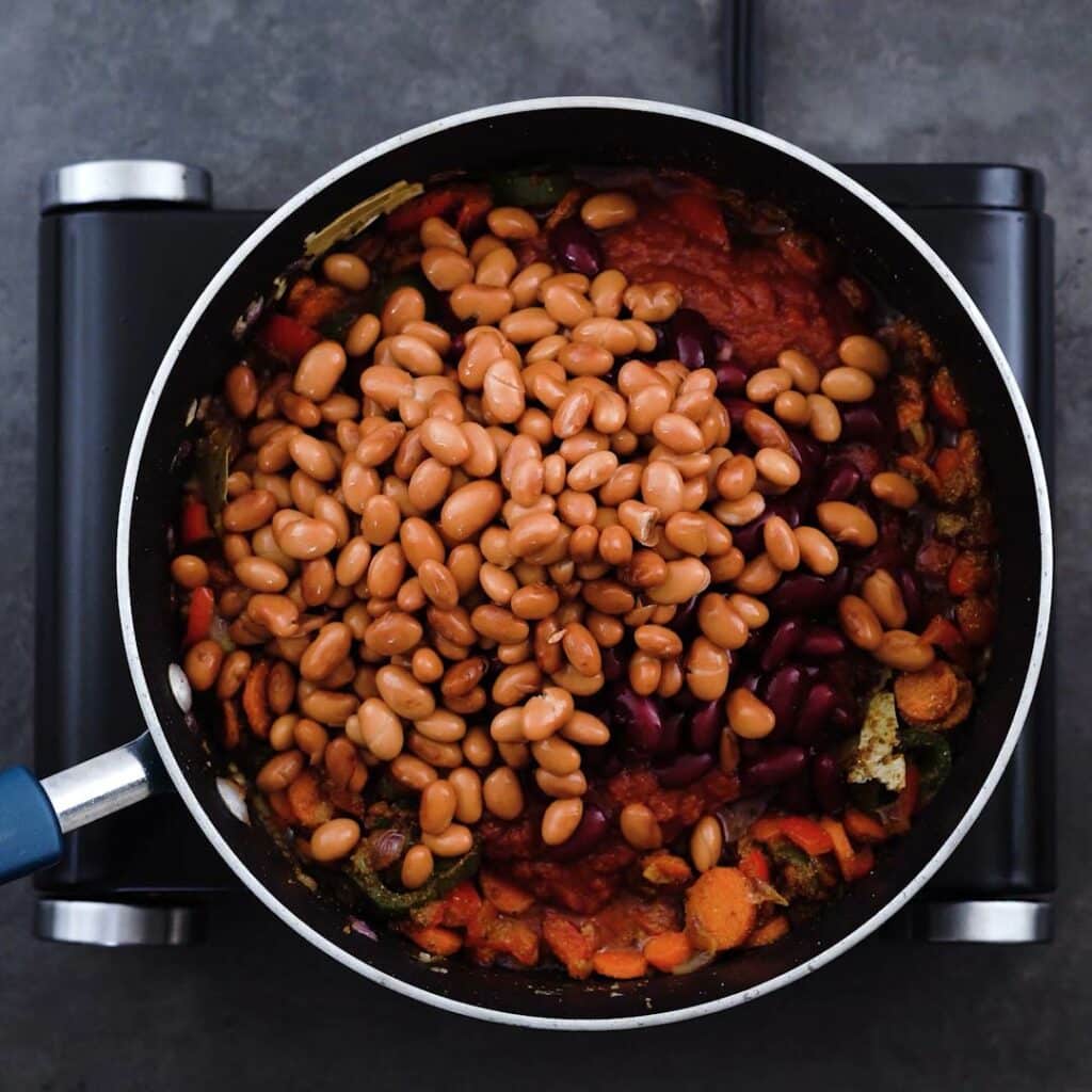 Veggies and beans in a pan.