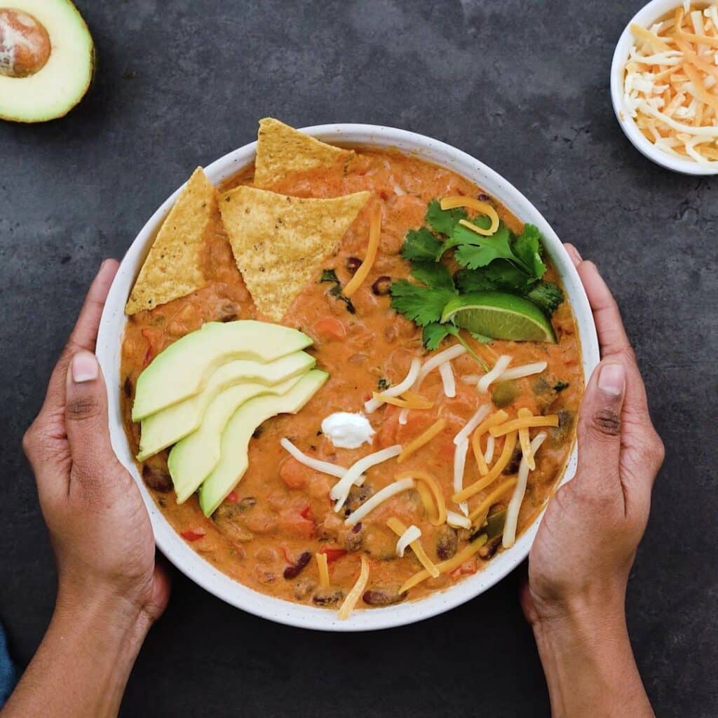Serving the Vegetarian Chili with avocado, tortilla chips, cheese and sour cream.