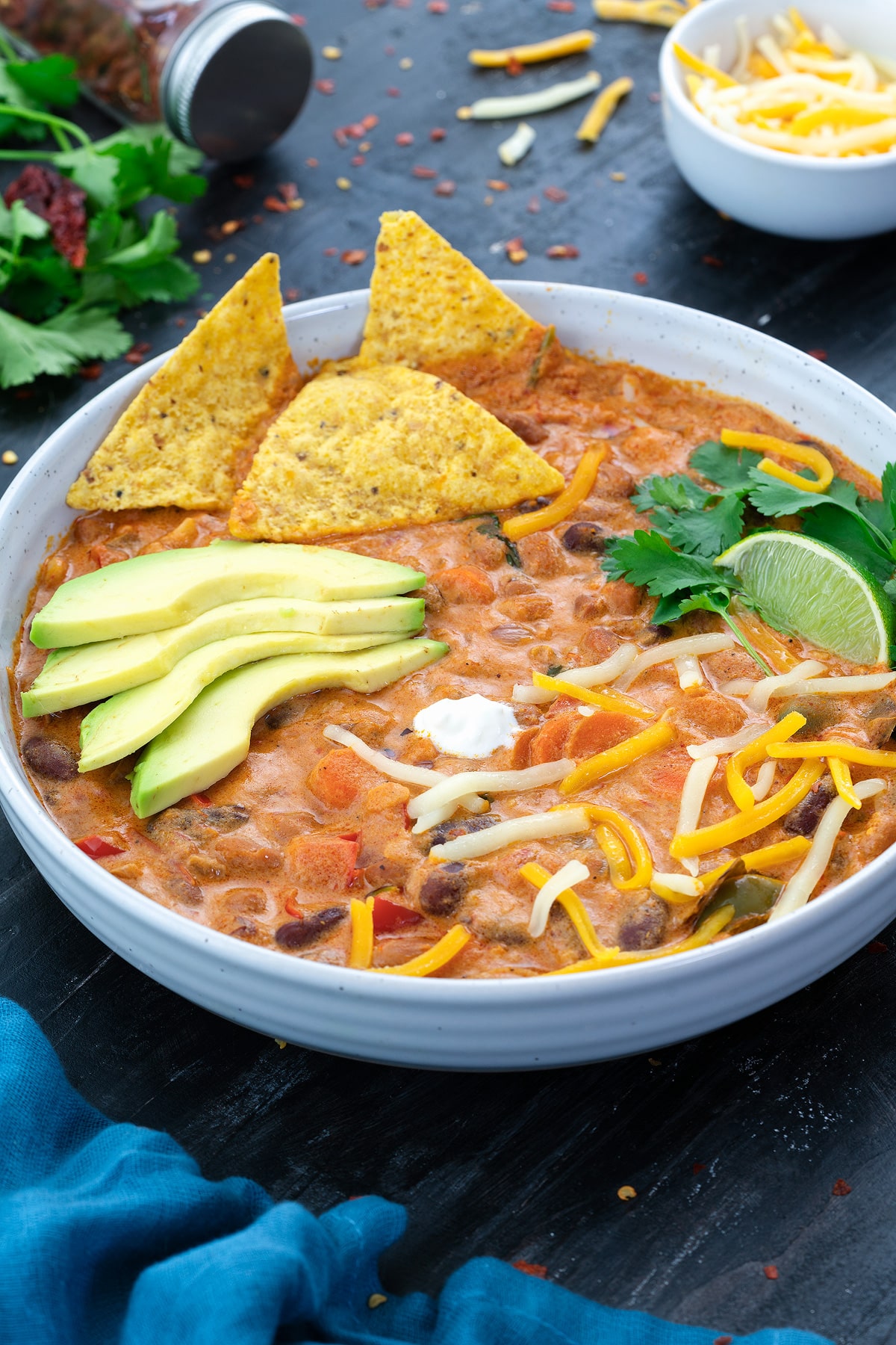 Homemade Vegetarian Chili in a white bowl with few ingredients around.