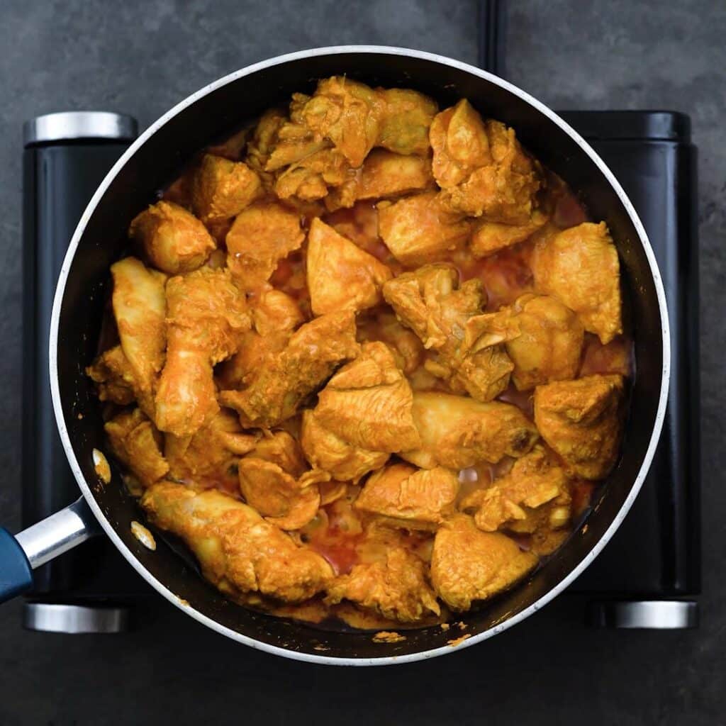 Marinated Chicken cooking in a pan.