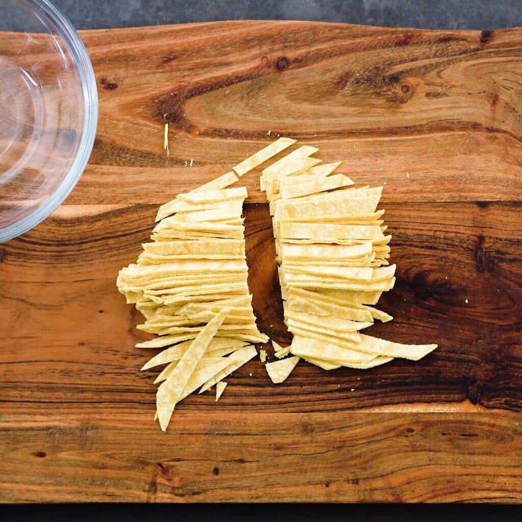 Cut Corn Tortillas on a wooden board.