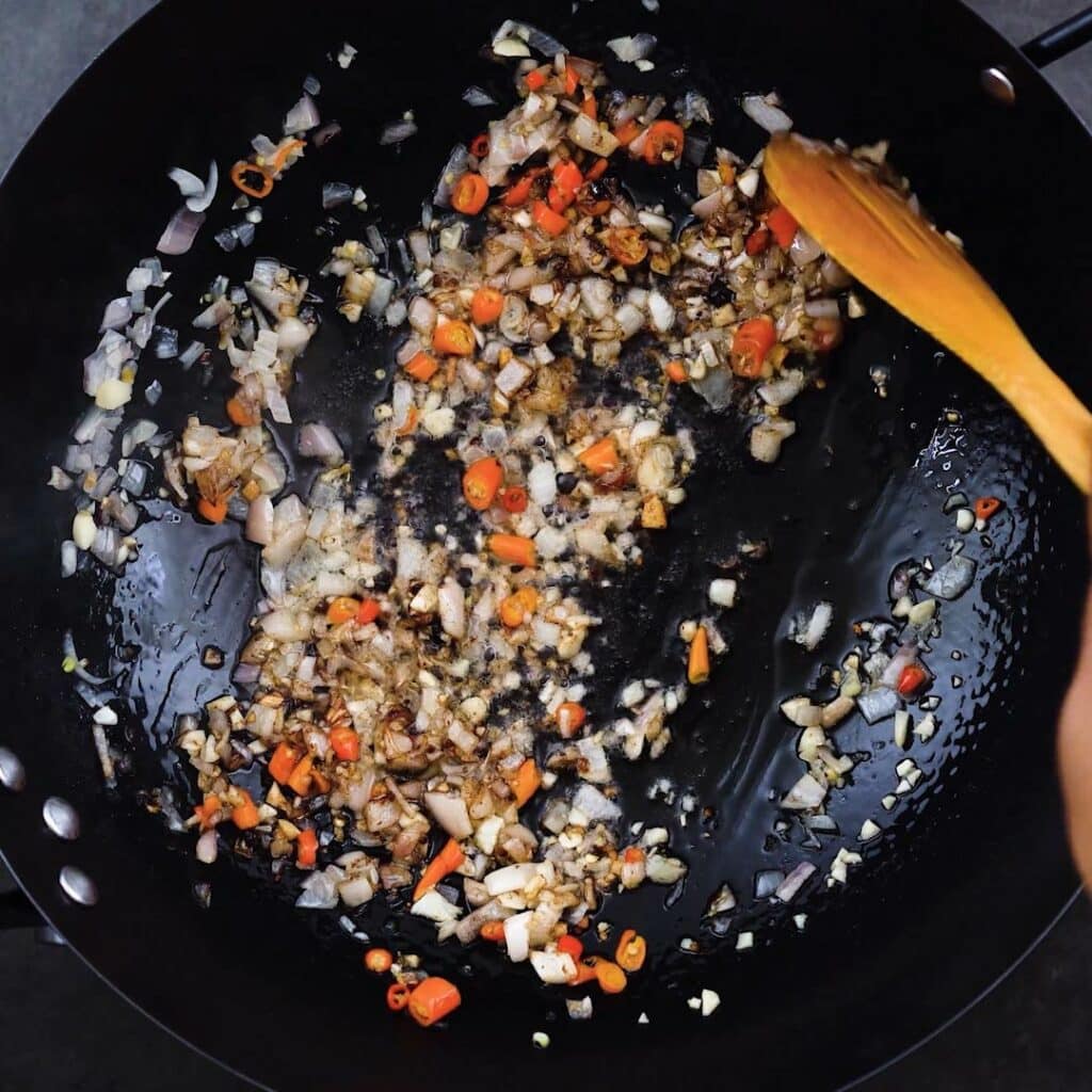 Sauteing the aromatics in a pan.