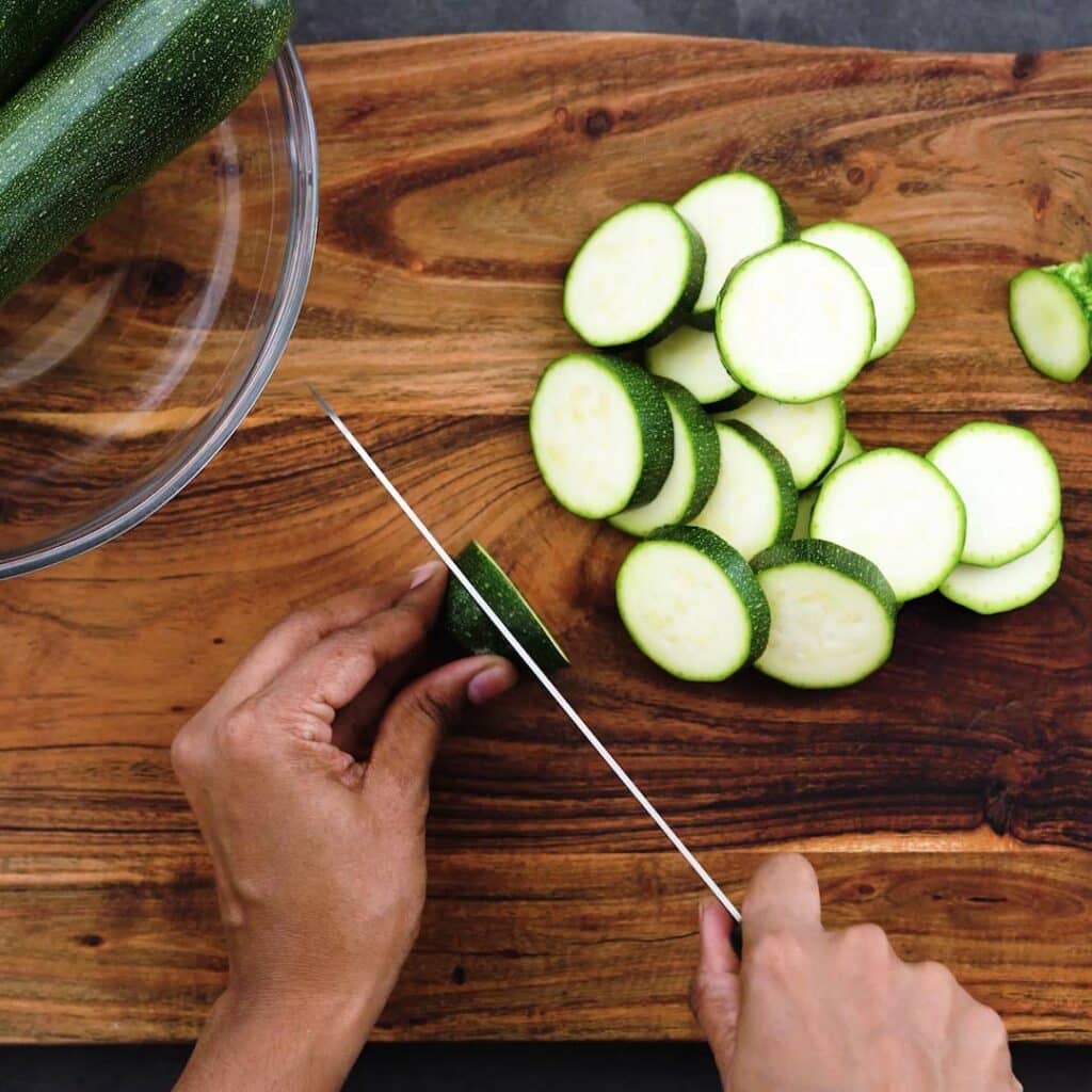 Cutting the Zucchini into circular shapes.
