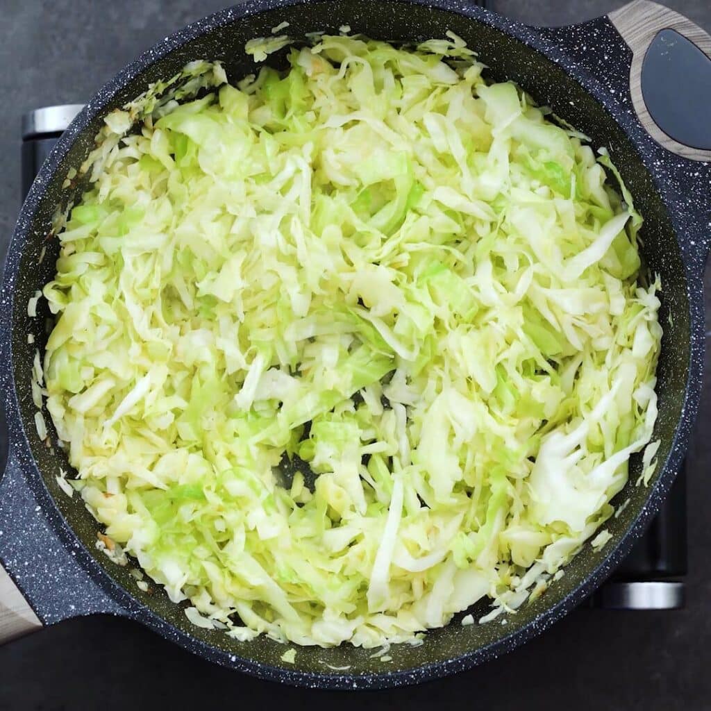 Sauteed cabbage in a pan.