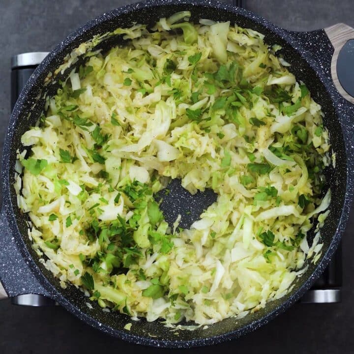 Sauteed Cabbage garnished with parsley leaves.
