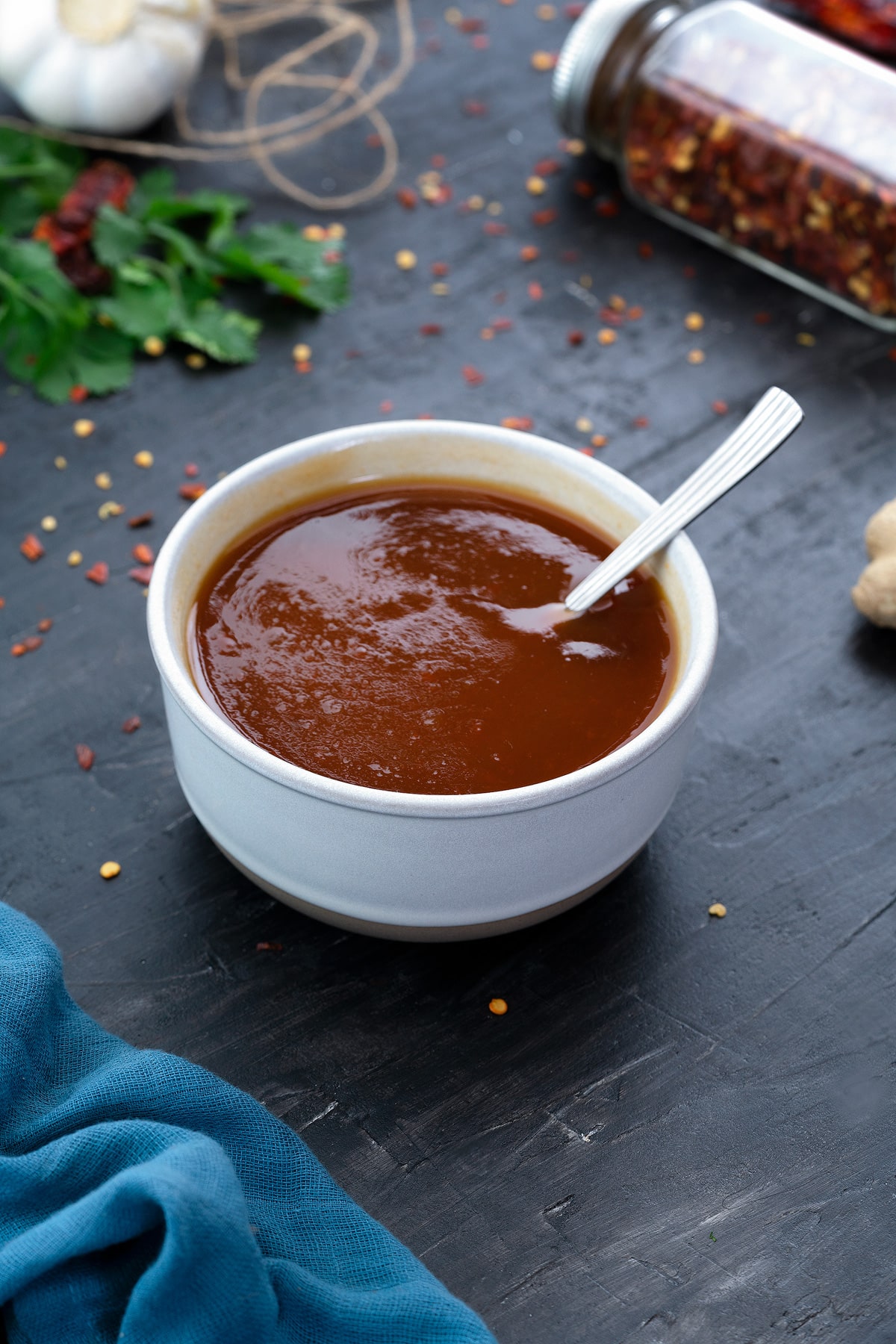 Homemade sweet and sour sauce in a white bowl.