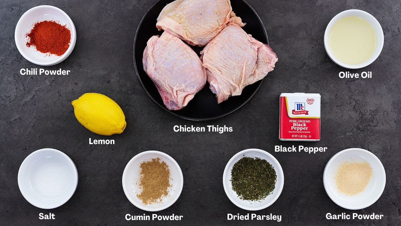 Air Fryer Chicken Thighs recipe Ingredients arranged on a grey table.
