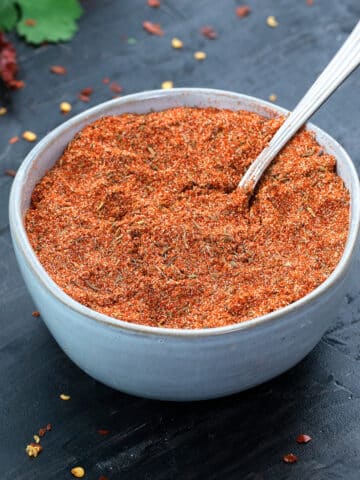 Homeamde Cajun Seasoning in a bowl with a spoon.