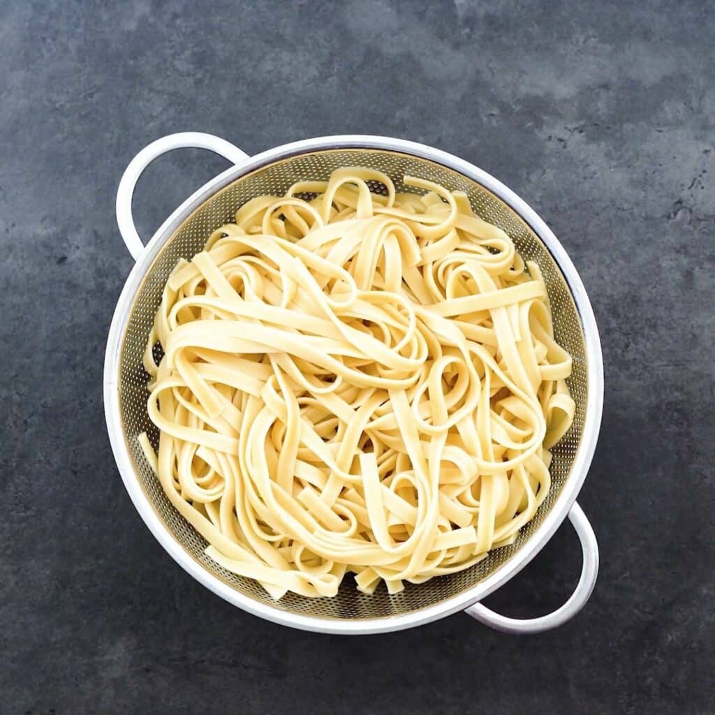 Cooked Fettuccine Pasta in a colander.