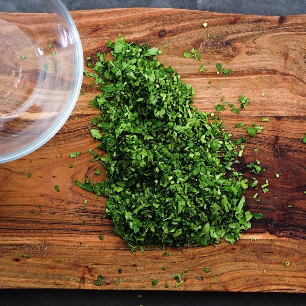 Finely Chopped Parsley Leaves on the cutting board.