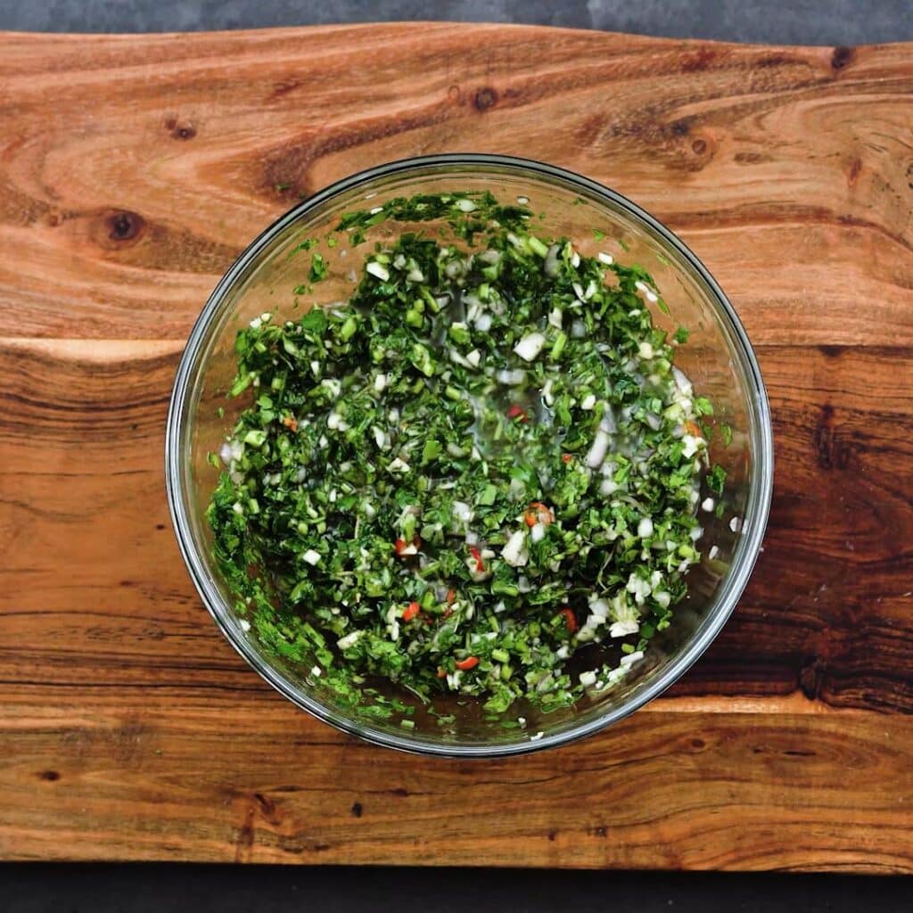A bowl with Chimichurri sauce mixture.