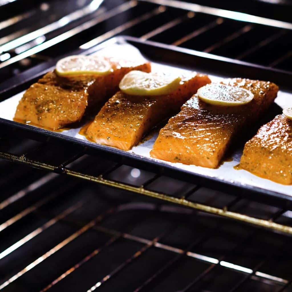 Seasoned Salmon fillets baking inside the oven.