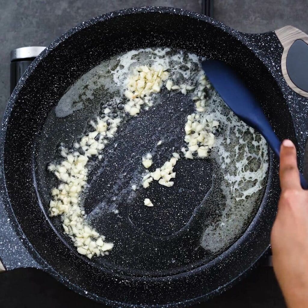 Sauteing the garlic in a pan.