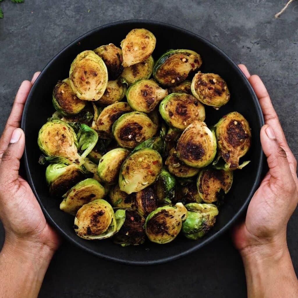 Serving Sauteed Brussels Sprouts in a bowl.