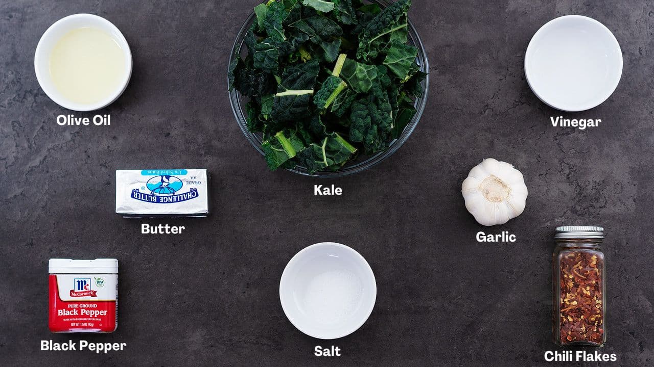 Sauteed Kale recipe Ingredients arranged on a grey table.