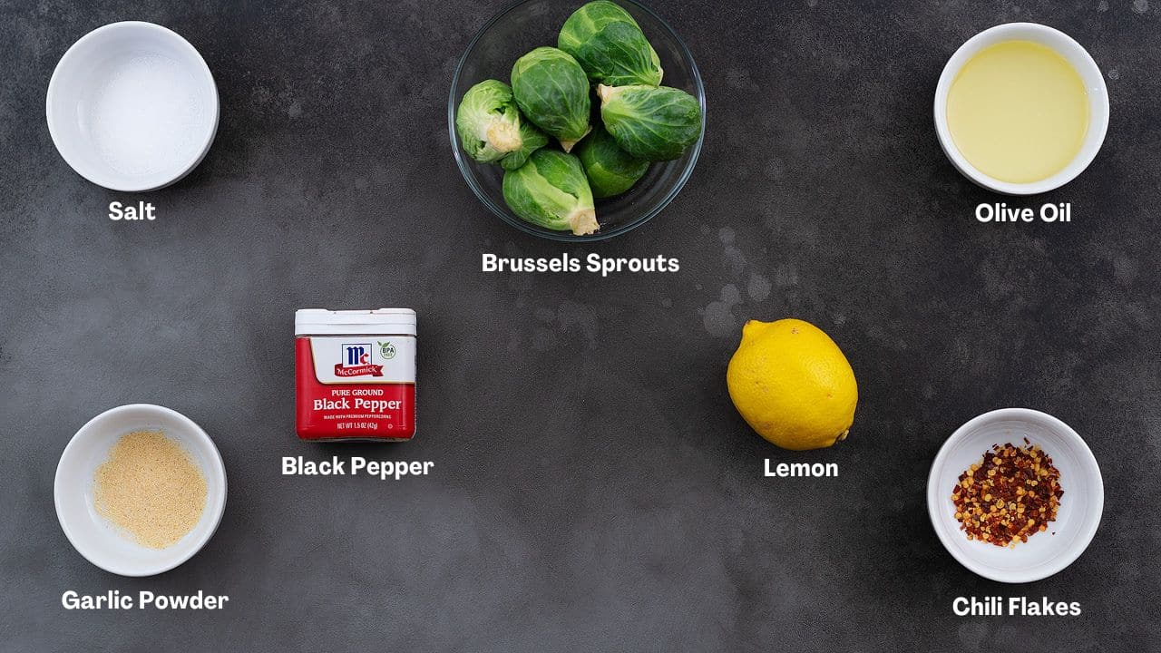 Air Fryer Brussels Sprouts recipe Ingredients arranged on a grey table.