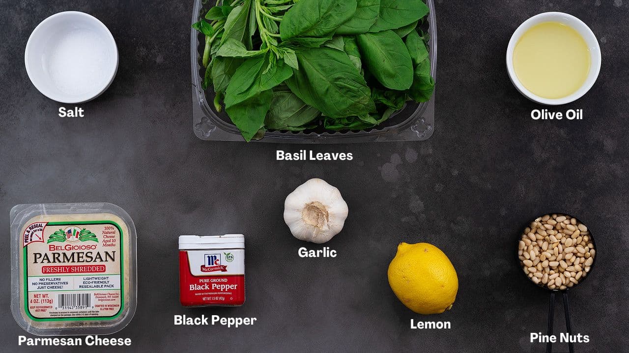Basil Pesto Sauce recipe Ingredients arranged on a grey table.