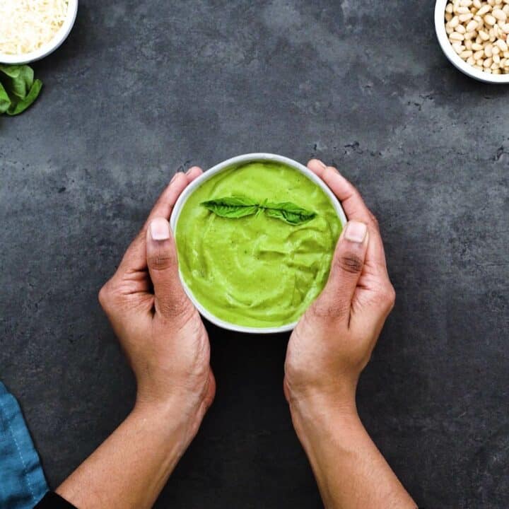 Serving smooth and creamy Basil Pesto Sauce in a white bowl.