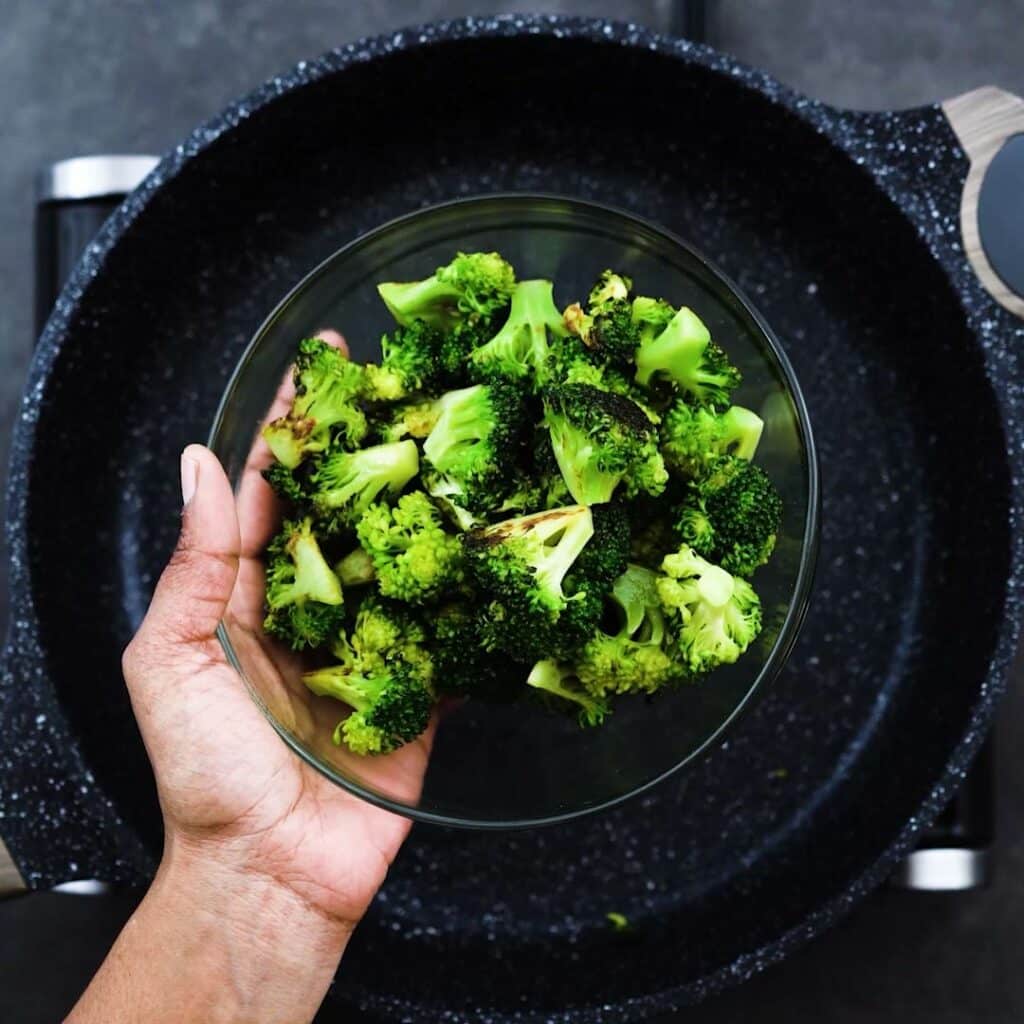 A bowl with stir fried broccoli.