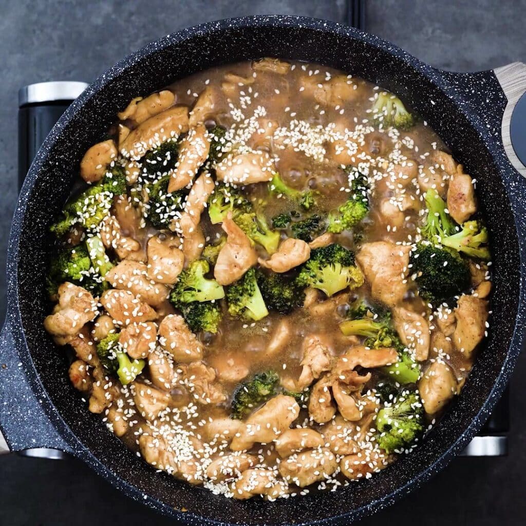 Chicken Broccoli stir fry garnished with sesame seeds.