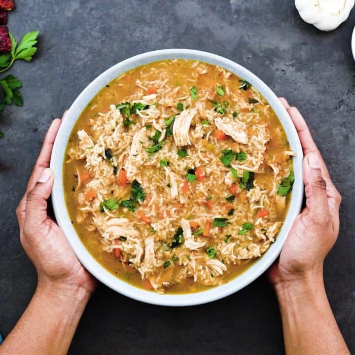 Serving chicken and rice soup in a bowl.