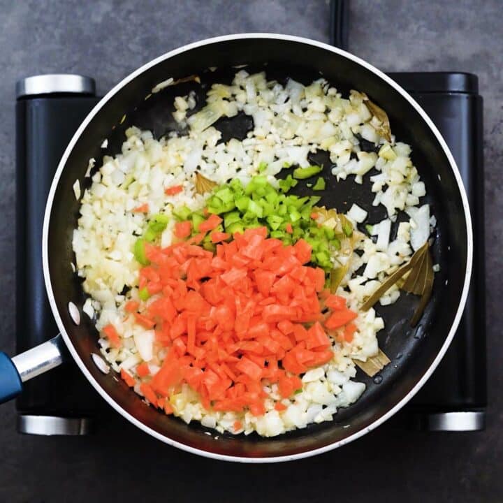 A pan with veggies and aromatics.