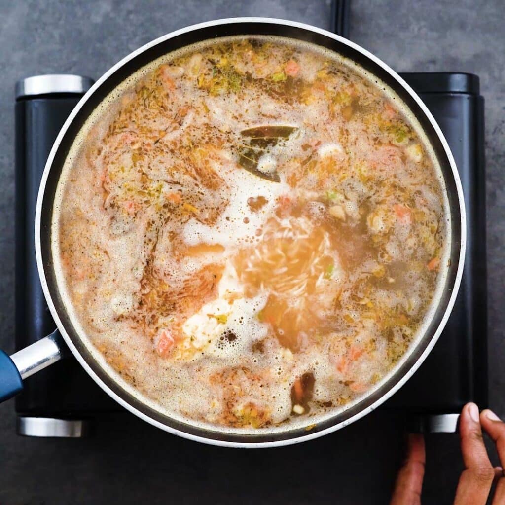 Simmering the chicken and rice soup.