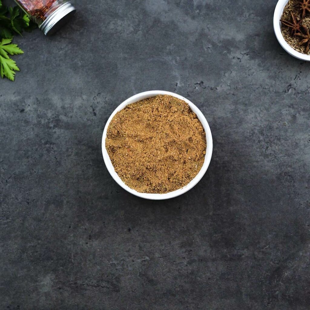 A white bowl with Chinese Five Spice Powder.