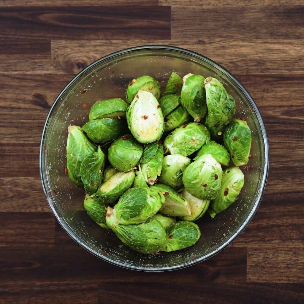 A bowl with seasoned brussels sprouts.