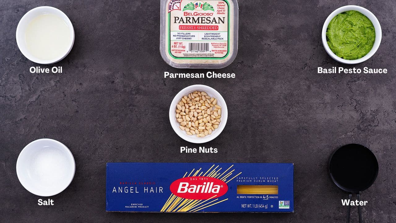 Pesto Pasta recipe Ingredients arranged on a grey table.