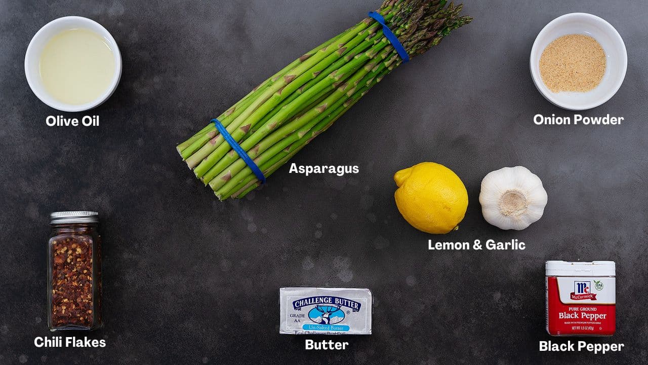 Sauteed Asparagus recipe Ingredients arranged on a grey table.