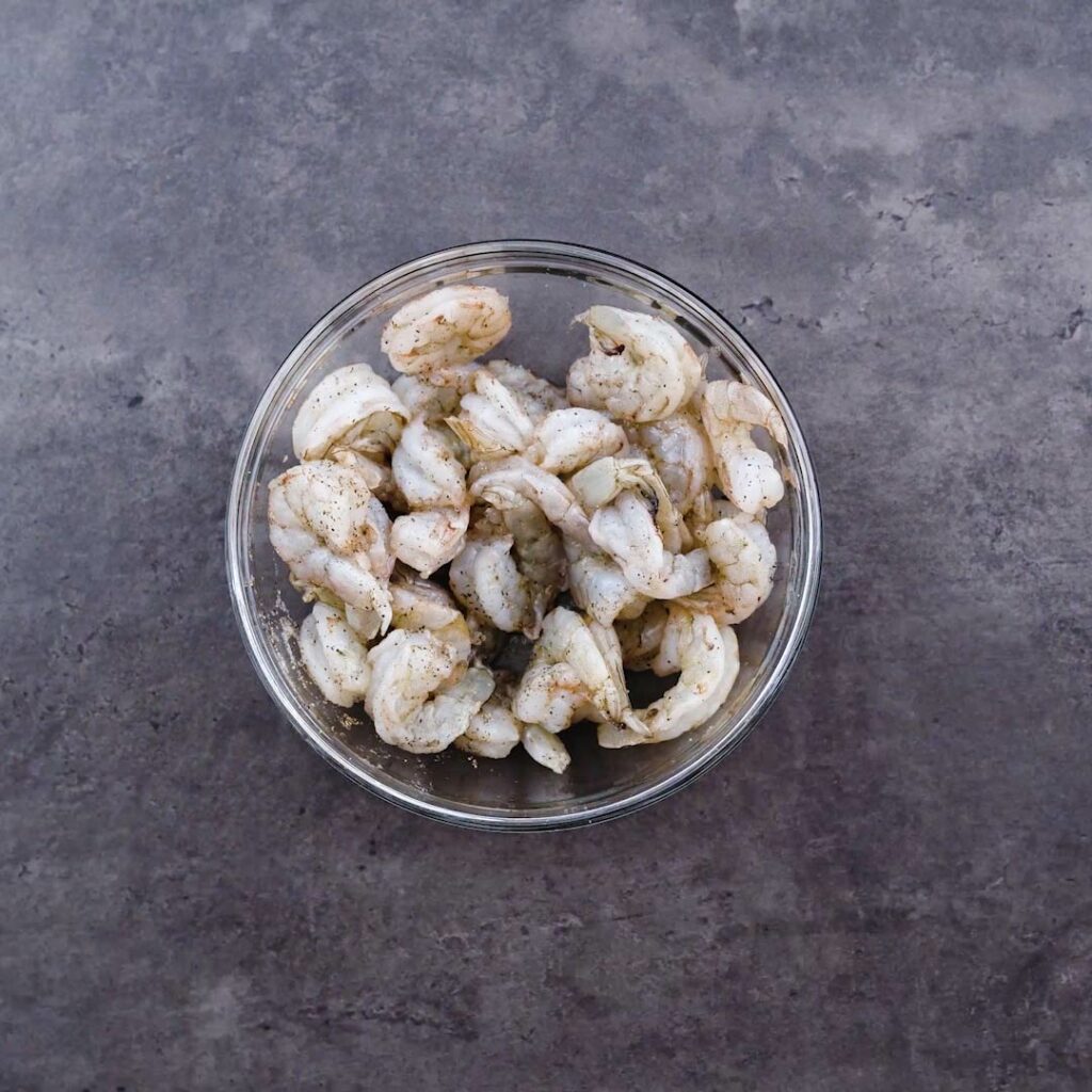 A bowl with seasoned shrimp.
