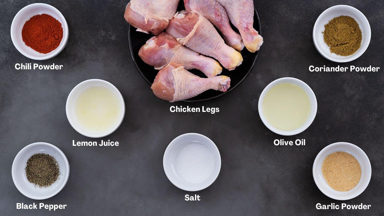 Air Fryer Chicken Legs (Drumsticks) recipe Ingredients arraged on a grey table.