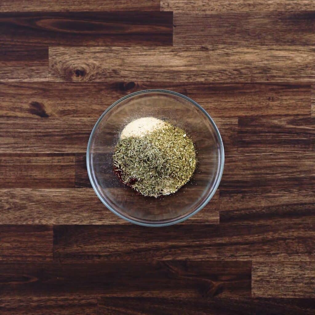 A bowl with spices and dried herbs.
