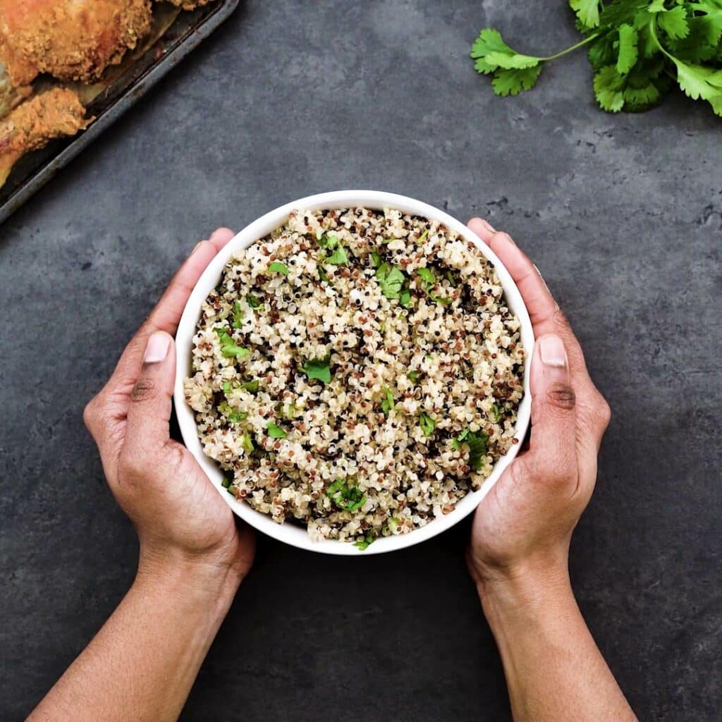 Serving quinoa in a white serving bowl.