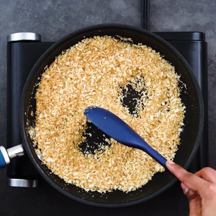 Toasting the breadcrumbs in a pan.