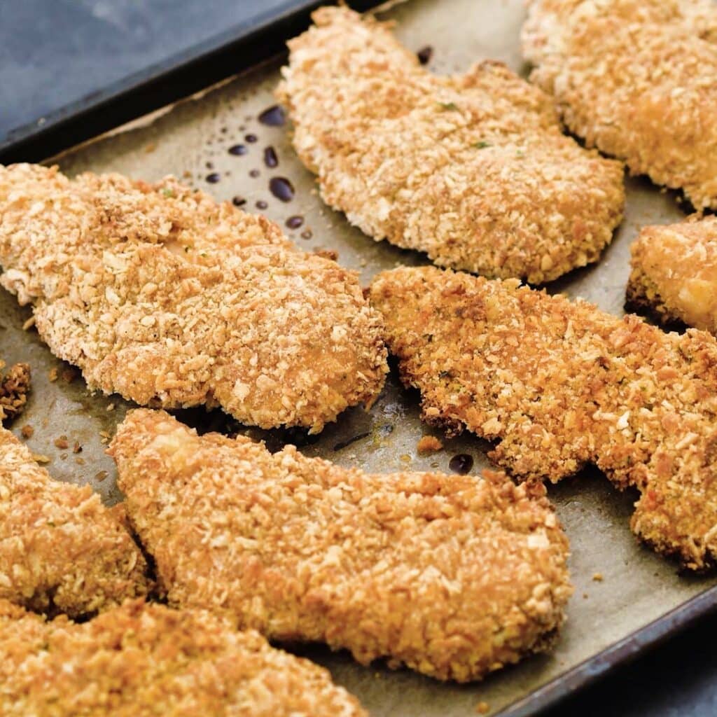 Crispy Oven Fried Chicken Tenders served in a baking tray.