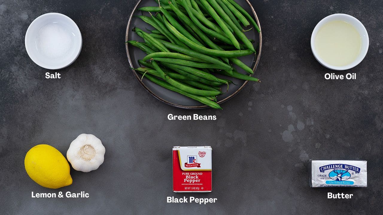 Sautéed Green Beans recipe Ingredients arranged on a grey table.