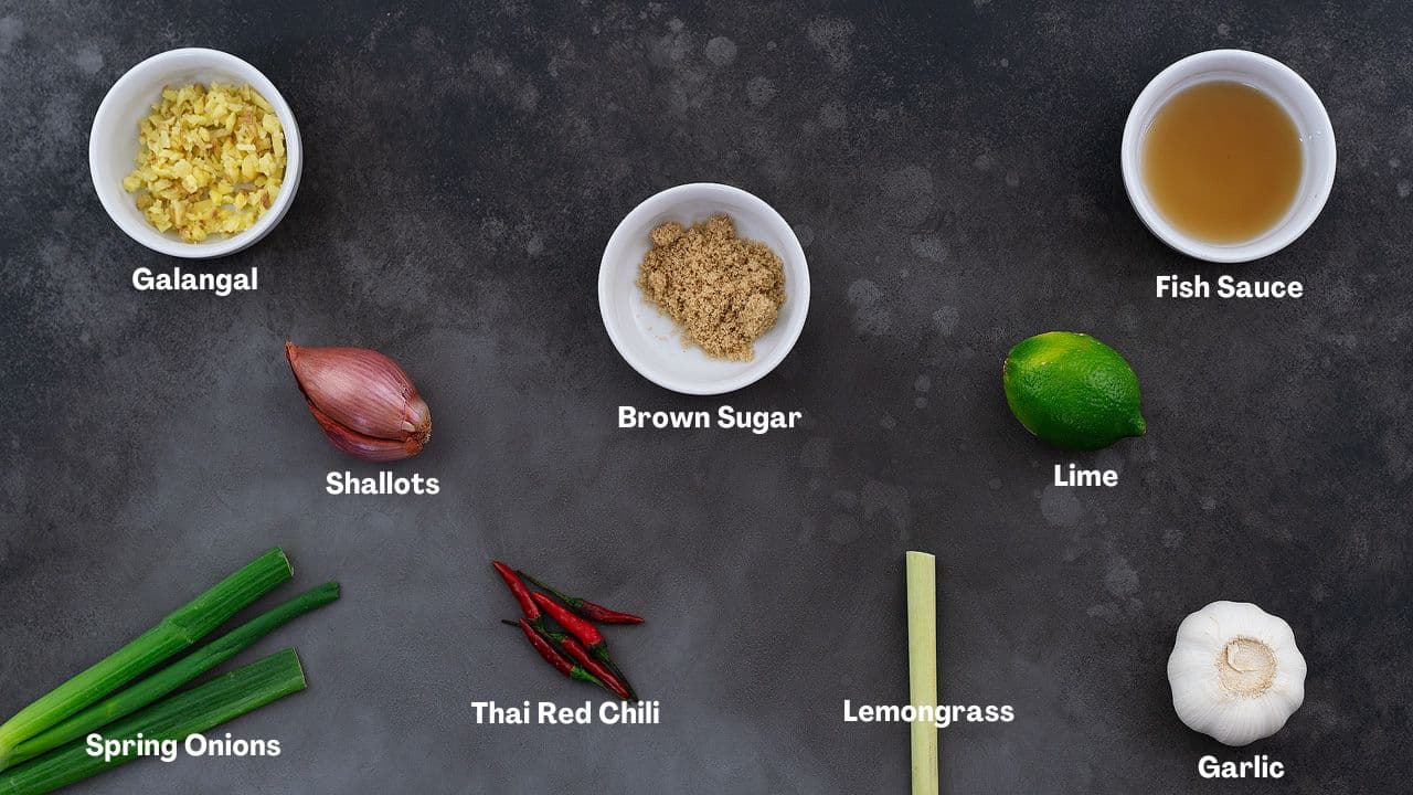 Tom Kha Gai Soup recipe Ingredients arranged on a grey table.
