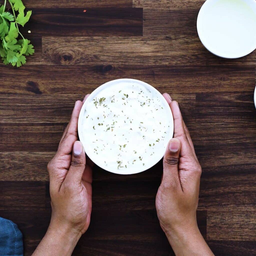 Serving Garlic Aioli in a white serving bowl.