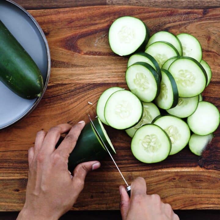 Slicing the cucumber using knife.