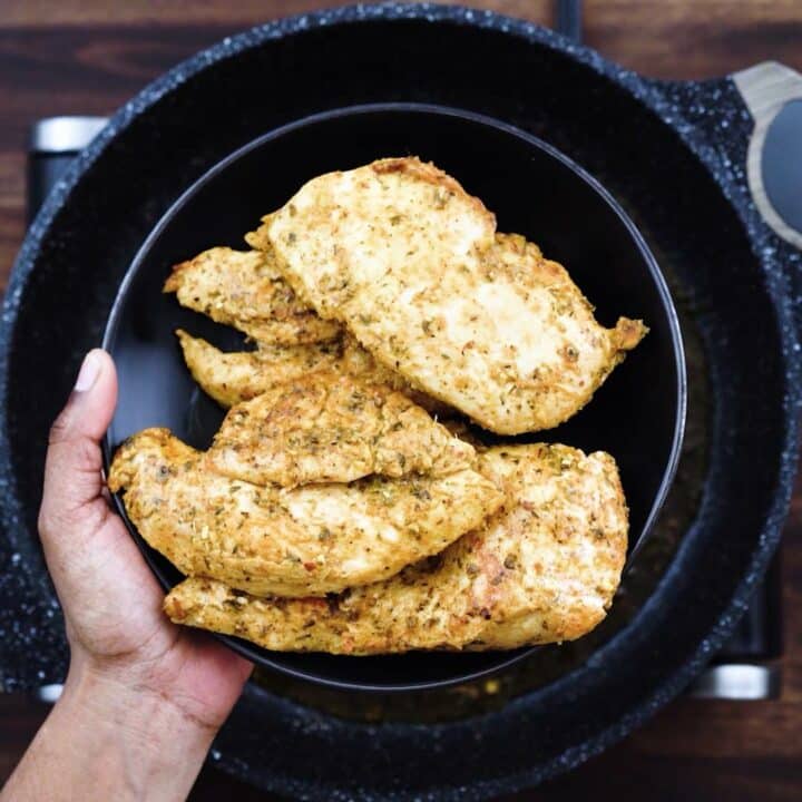 Fried Chicken breast in a black plate.
