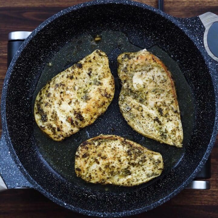 Chicken breast frying in the pan.