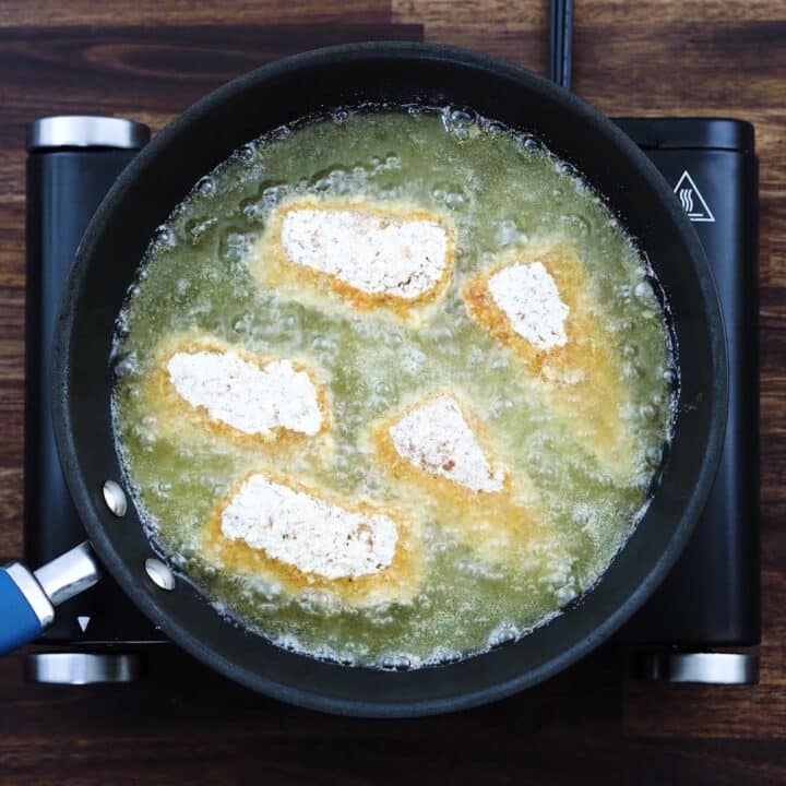 Breaded Fish fillets frying in a pan.