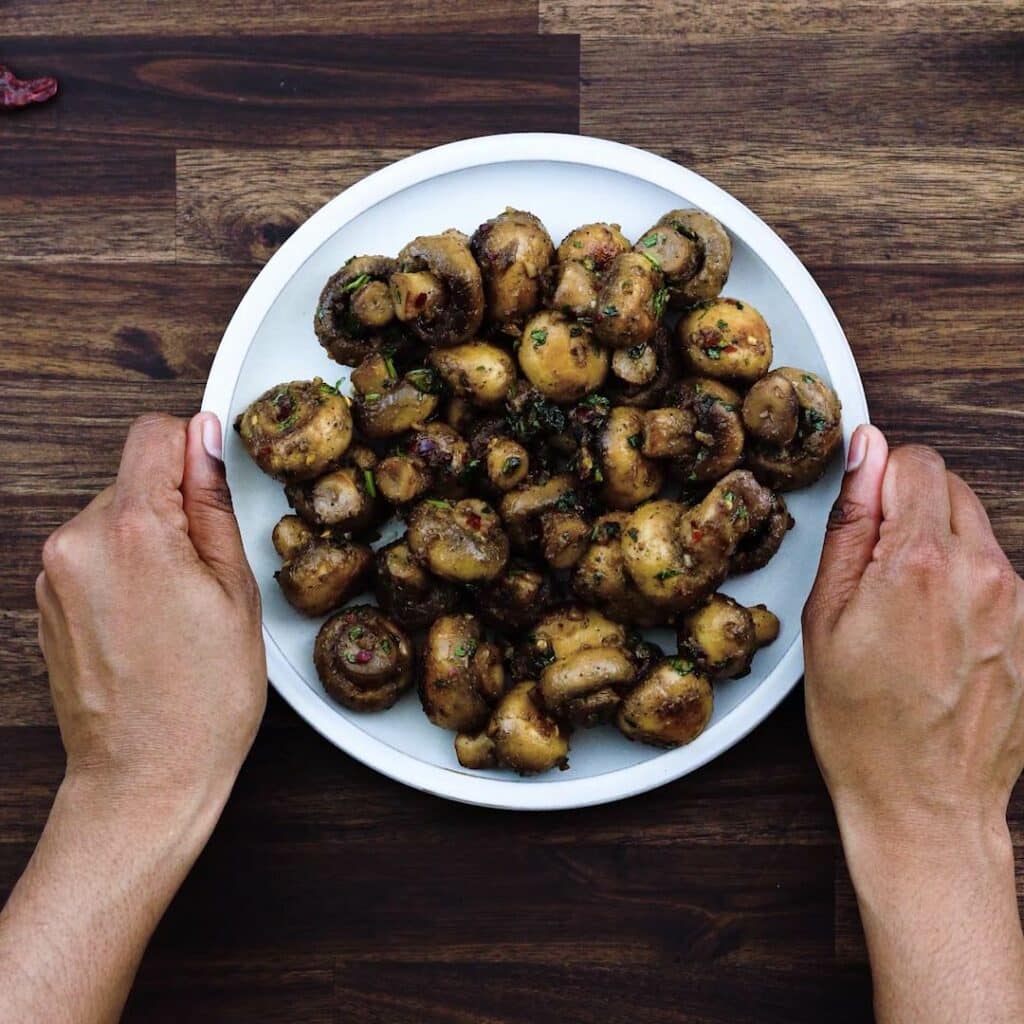 Serving Garlic Mushrooms in a white plate.