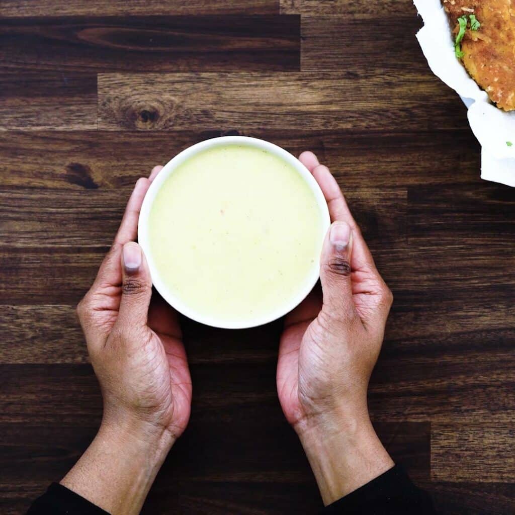 Serving the Honey Mustard Sauce in a white bowl.