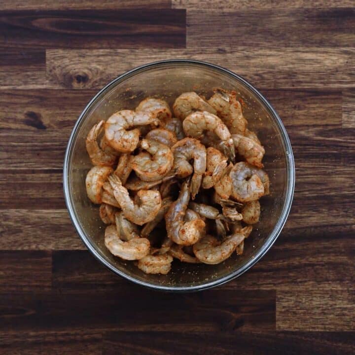 A bowl with seasoned shrimp.