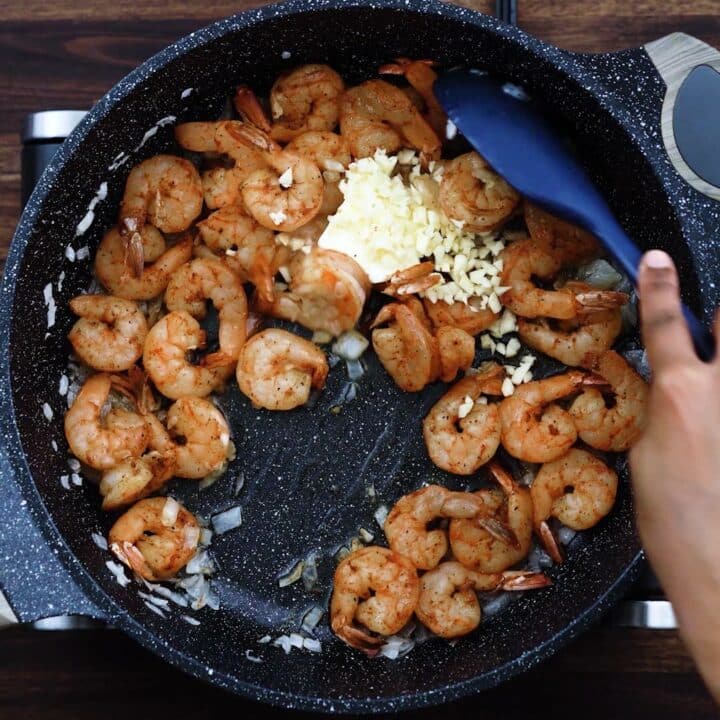 Sauteing the garlic with butter along with shrimp.