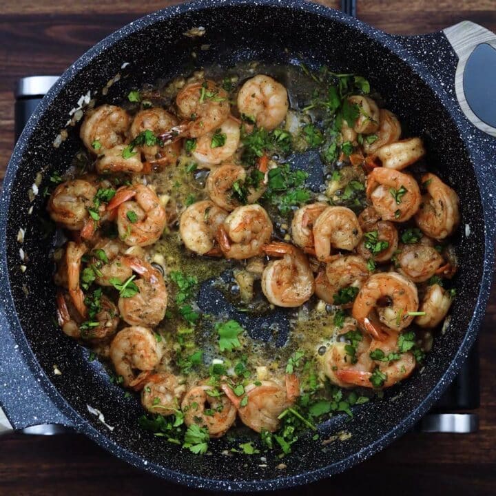 Sauteed Shrimp garnished with cilantro leaves.